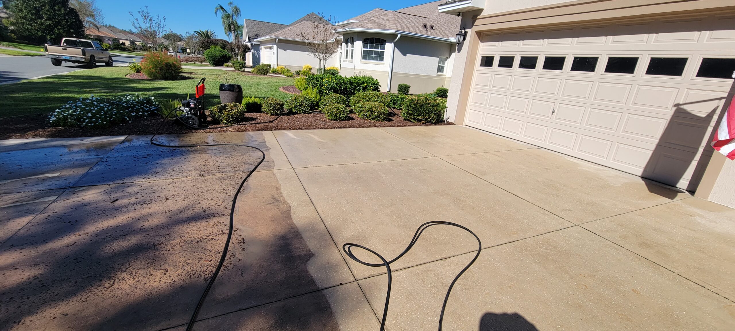 Residential driveway pressure washing service in The Villages, Florida removing dirt and surface buildup