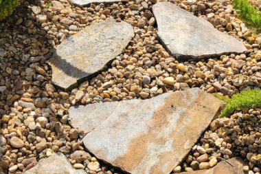 Pressure washing around decorative rock and natural stone landscaping in The Villages, Florida