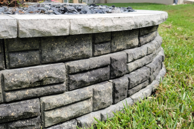 Cleaned stacked stone retaining wall after pressure washing in The Villages, Florida